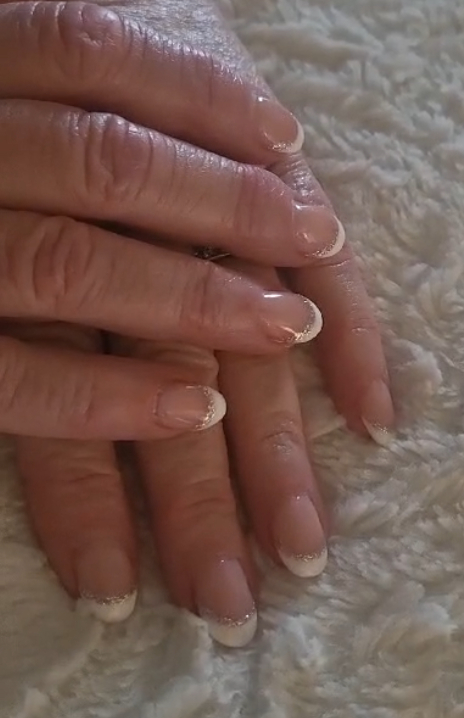 Natural nails with white and gold glitter french tips